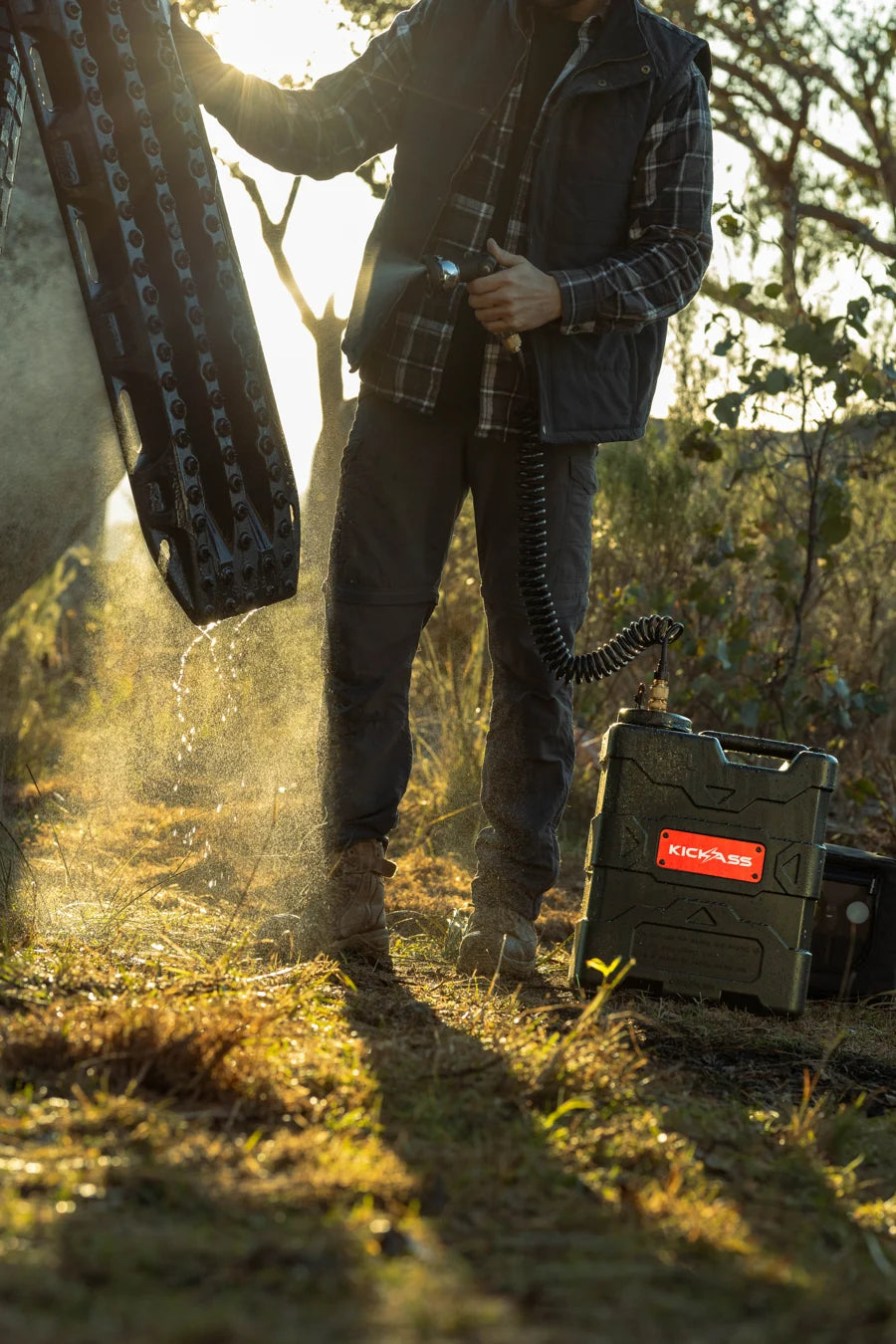 Rinsing a recovery board with an AquaBoss portable water system at sunset