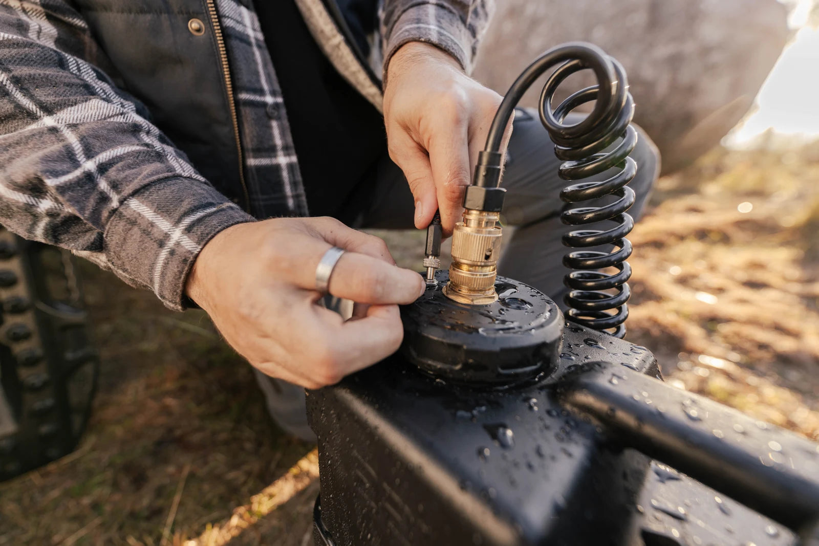 Connecting the 12V power lead to the AquaBoss pump beside its brass hose fitting